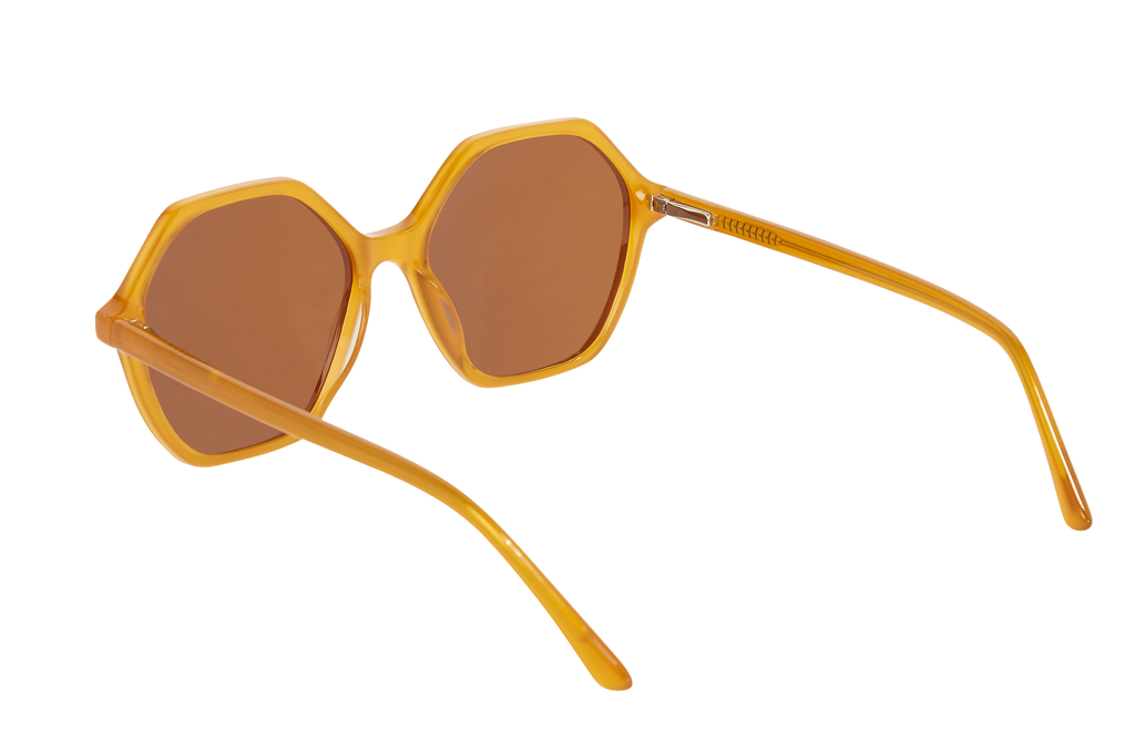 Side view of Frank and Lucie Eyewill sunglasses in Roussillon – sculpted temples and octagonal lenses in translucent amber yellow frame